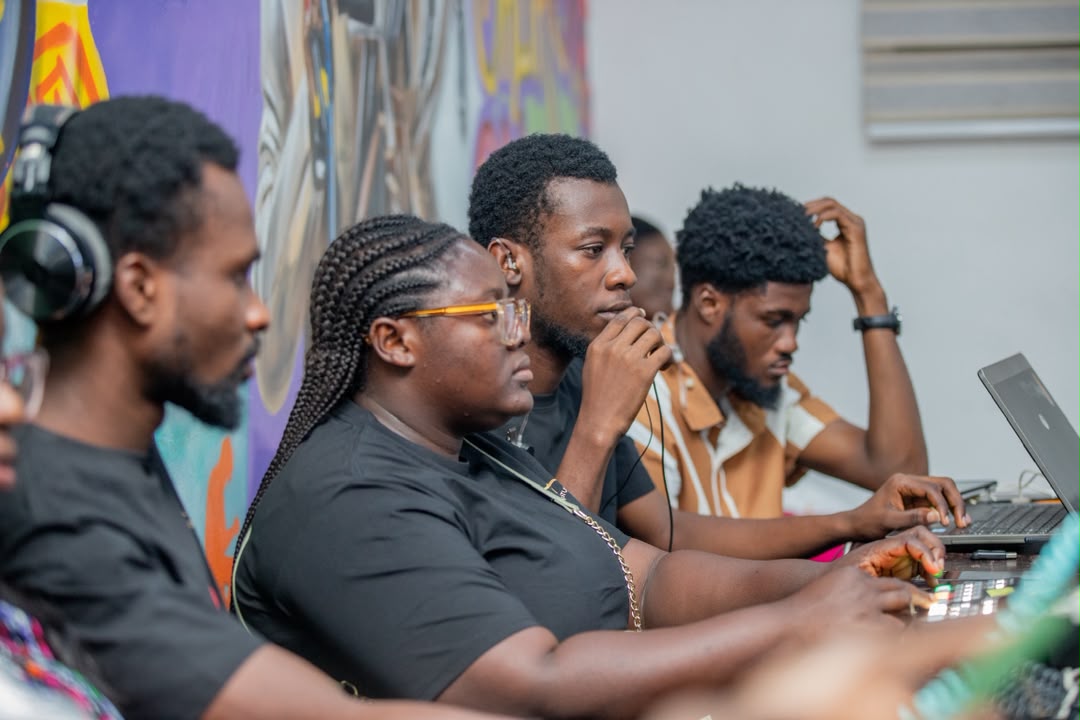 Essuman collaborating at a production desk
